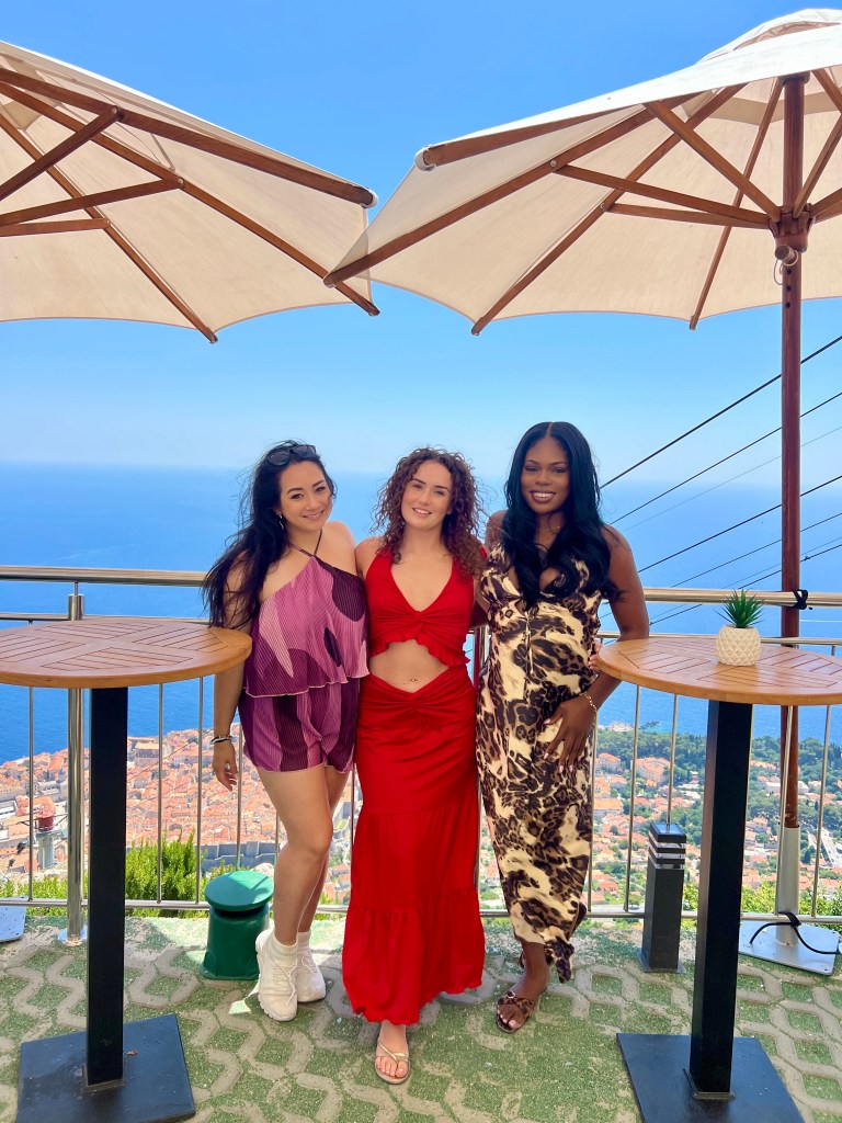 Friends at the Panorama Rooftop Restaurant with the view of Dubrovnik Croatia.